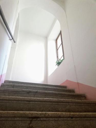 a stairway with a window in a building at Althamer Palace Apartments in Arco