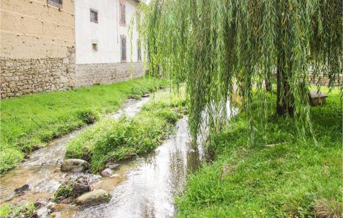 a stream of water in a field next to a building at La Féculerie in Grandrif