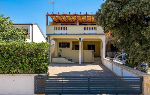 a house with a fence in front of it at Amazing Apartment In Mandre With Wifi in Mandre