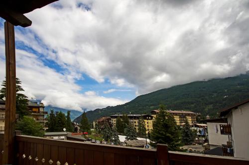 a view from a balcony of a town with a mountain at Assietta in Sauze dʼOulx
