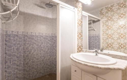 a white bathroom with a sink and a shower at Roc De San Gaiet in Comarruga