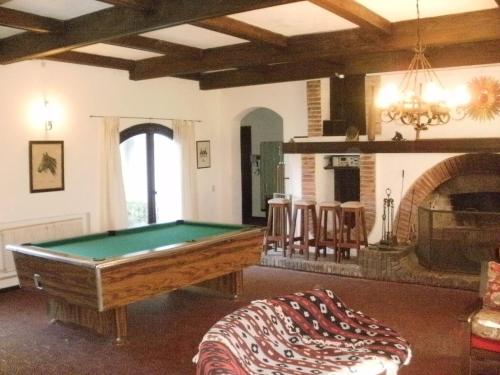 a room with a pool table and a fireplace at Haras L'Etalon in Pergamino