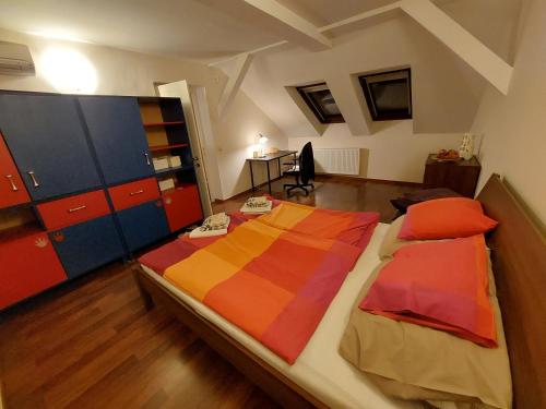 a bedroom with a large bed with colorful sheets and cabinets at Queen Zita Apt 130 m2 near Chain Bridge in Budapest