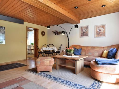 a living room with a couch and a table at Apartment in Thuringian Forest with garden in Oberweißbach