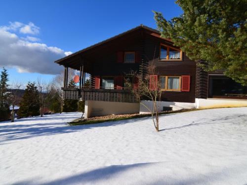 a house with a balcony in the snow at Relaxing holiday home in Deilingen with terrace in Deilingen