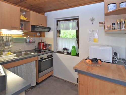 cocina con fregadero, fogones y ventana en holiday home in Langewiesen, en Langewiesen