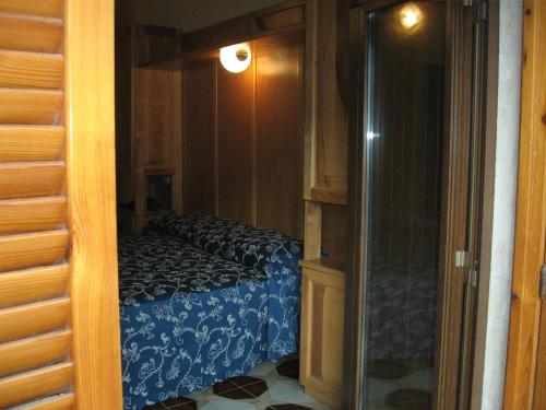 a bedroom with a bed and a glass door at Hotel Casale in Isola del Gran Sasso dʼItalia