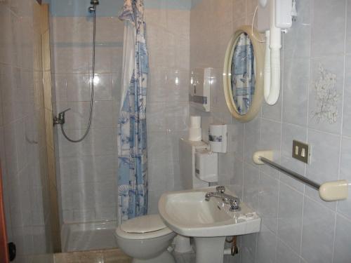 a bathroom with a toilet and a sink and a shower at Hotel Casale in Isola del Gran Sasso dʼItalia