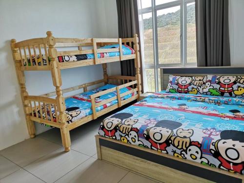 a bedroom with two bunk beds with hello kitty sheets at W3WarmStay@GoldenHills/3RPenthouse/WiFi/PasarMalam/2carpark in Brinchang
