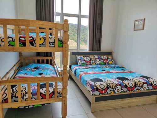 a bedroom with two bunk beds next to a window at W3WarmStay@GoldenHills/3RPenthouse/WiFi/PasarMalam/2carpark in Brinchang