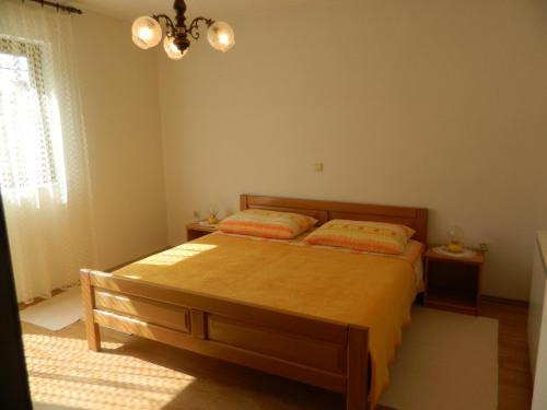 a bedroom with a bed and a window at Vacation home Kuća za Odmor in Krasno Polje