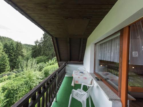 a balcony of a house with a table and chairs at Holiday home in Thuringia with terrace in Friedrichroda