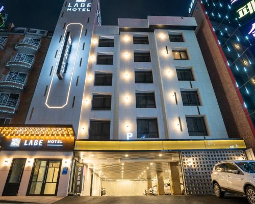 a building with a car parked in front of it at LABE Hotel in Jeonju