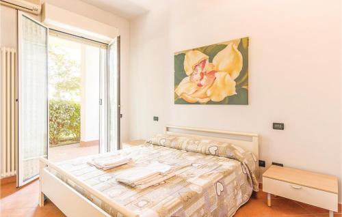 a bedroom with a bed and a large window at Orizzonte 3 in Lido di Dante