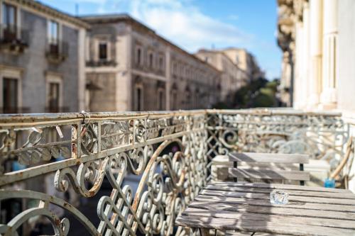 a bench in front of a bridge with buildings at San Demetrio in Catania