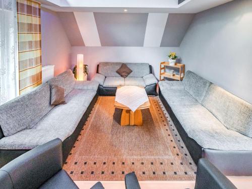 a living room with two couches and a table at Madfeld Apartment Retreat in Brilon