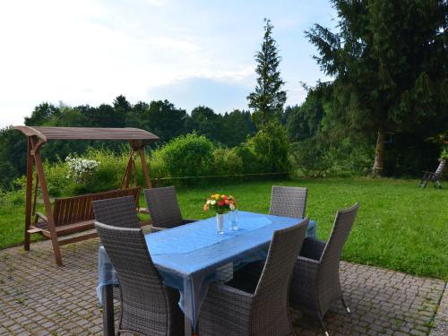 a blue table with chairs and a gazebo at Geräumige Ferienwohnung in Stocking in Waldnähe in Waldkirchen
