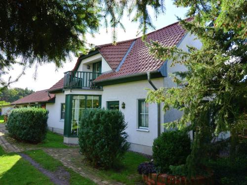 a white house with a red roof at Cozy Holiday Home in Kappe with Balcony in Kappe