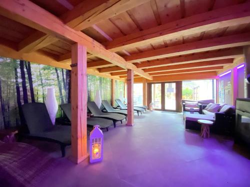 a living room with couches and chairs and a tv at Penzion Bystrinka in Tale