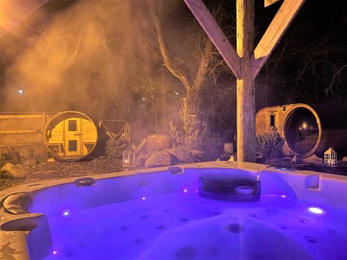 a jacuzzi tub in a backyard at night at Penzion Bystrinka in Tale