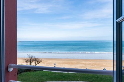 a view of the beach from a window at Castaline in Saint-Cast-le-Guildo