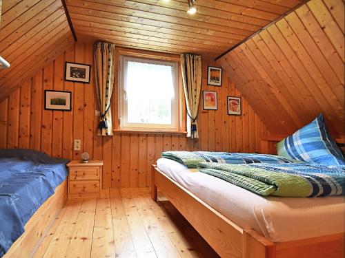 a bedroom with a bed and a window in a cabin at Cottage in Black Forest near ski slopes in Sankt Georgen im Schwarzwald