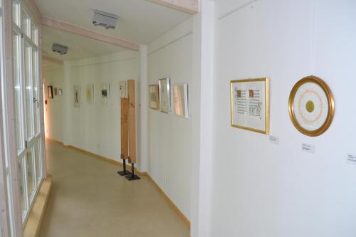 a hallway in a hospital with a clock on the wall at Haus der Begegnung Heilig Geist in Burghausen