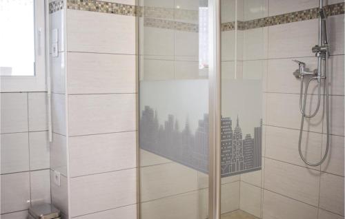 a shower with a glass door with a city at Lovely Home In Plévenon Cap Fréhel in Plévenon