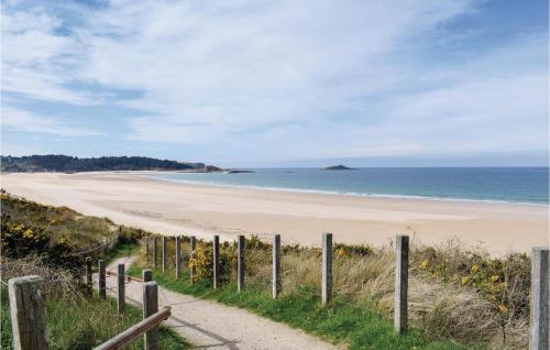 a path leading to a beach with a fence at Lovely Home In Plévenon Cap Fréhel in Plévenon