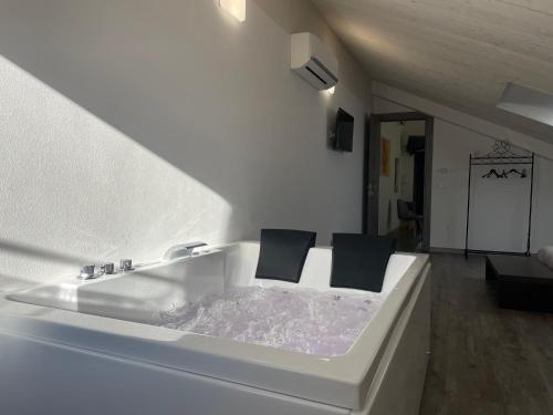 a white bath tub with two black pillows on it at Villa Liliana in Cervia