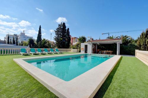 a swimming pool in the middle of a yard at Villa Maravillas 2 by Slow Villas in El Arenal