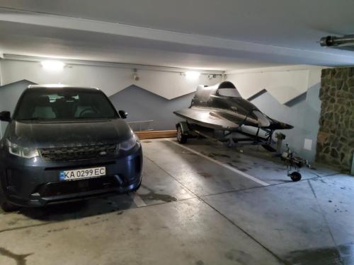 a car parked in a garage with a fighter jet at Apartmány Tri sestry Jasná in Demanovska Dolina