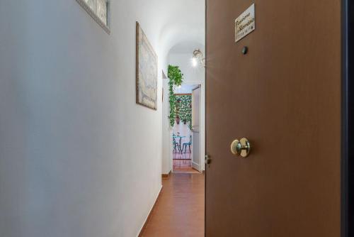 a hallway with a door leading to a dining room at Passione Romana Apartment in Rome