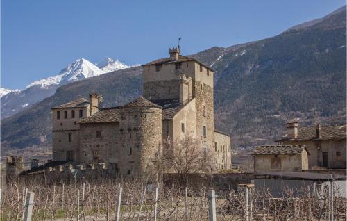 an old castle with a mountain in the background at Valsavarenche in Maisonasse