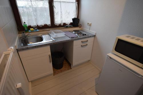 a small kitchen with a sink and a microwave at AB Apartment Waiblingen in Waiblingen