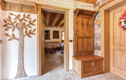 a hallway with a door and a tree on the wall at Alle Sorgenti in Comeglians