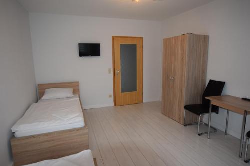 a room with a bed and a desk and a table at AB Apartment Waiblingen in Waiblingen
