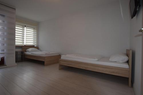 a room with two beds and a window at AB Apartment Waiblingen in Waiblingen