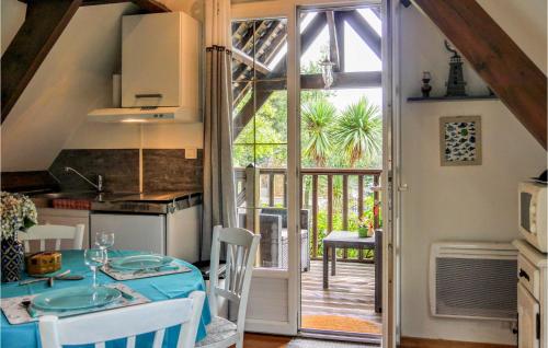 a kitchen with a table and a door to a patio at 1 Bedroom Cozy Apartment In Vasteville in Vasteville