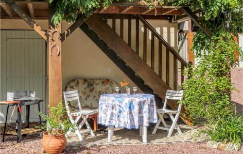 a table and chairs sitting under a wooden roof at 1 Bedroom Cozy Apartment In Vasteville in Vasteville
