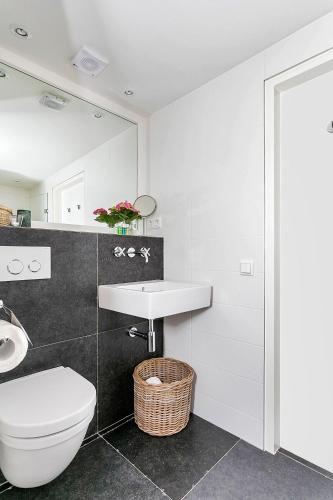 a bathroom with a toilet and a sink at Van Gogh Cottage in Nuenen