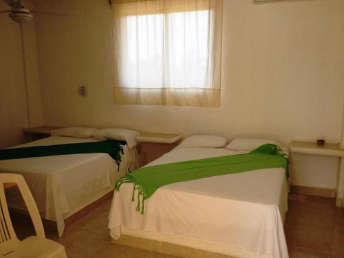 מיטה או מיטות בחדר ב-Quinta DIAMANTE Hotel