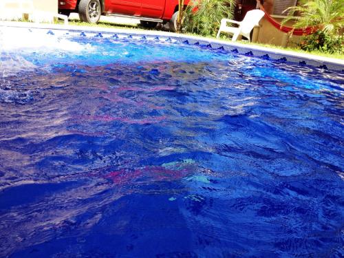 a large swimming pool filled with blue water at QUINTA DIAMANTE villas&hotel in Barra Vieja