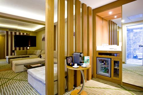 a living room with a couch and a tv at Holiday Inn Gaziantep, an IHG Hotel in Gaziantep