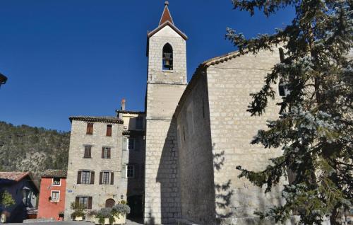 Une ancienne église en pierre avec une tour d'horloge. dans l'établissement Holiday Home Cuebris I, à Cuébris