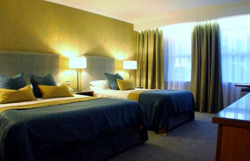a hotel room with two beds and a window at Downings Bay Hotel in Downings