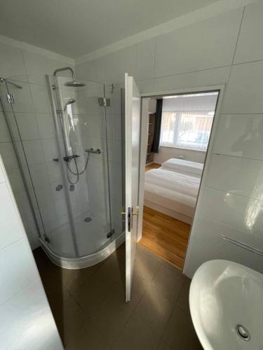 a bathroom with a shower and a toilet and a sink at pension-seegarten in Norddeich