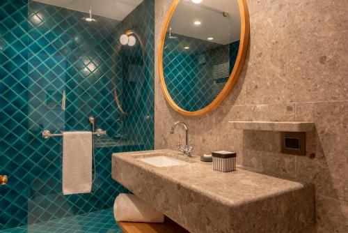 a bathroom with a sink and a mirror at Faloria Mountain Spa Resort in Cortina dʼAmpezzo