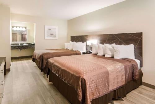 Кровать или кровати в номере Quality Inn & Suites Dallas-Cityplace