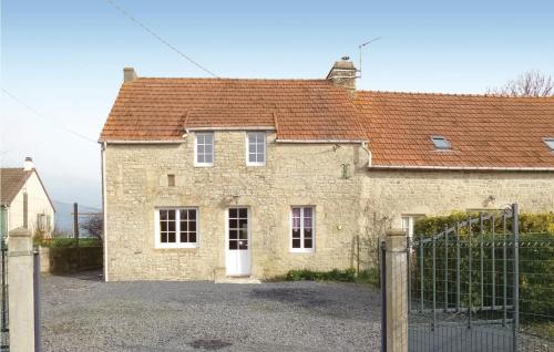 une ancienne maison en briques avec un portail en face de celle-ci dans l'établissement Beautiful Home In Englesqueville Percee, à Englesqueville-la-Percée